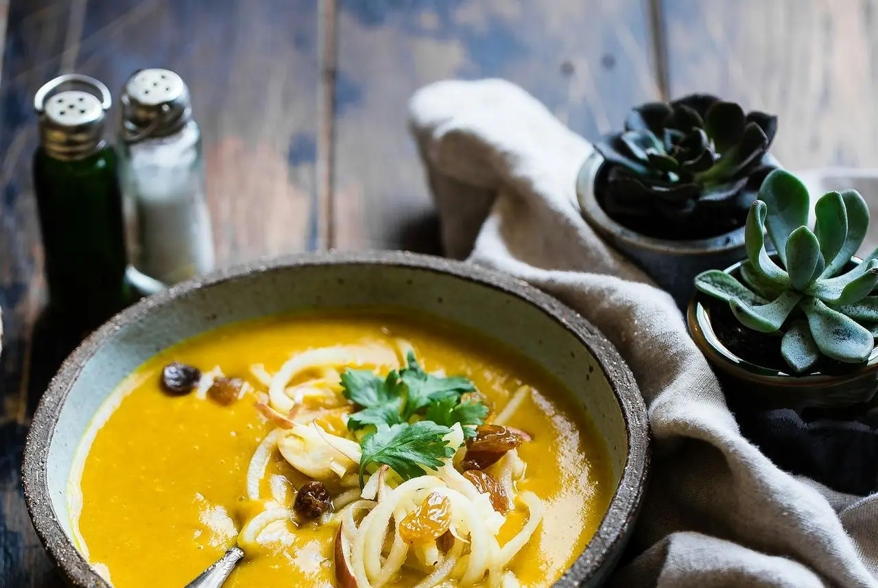 three noodle dishes with orange sauces in food photography